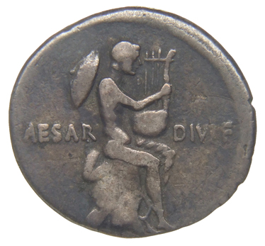 Augustus reverse — Naked male figure seated right on cloak on rock, holding lyre, petasus behind