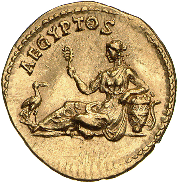 RIC II Hadrian 296j Hadrian reverse, Aegyptus lagert nach l. In der r. Hand hält sie eine Rassel (sistrum). Der l. Arm ist...