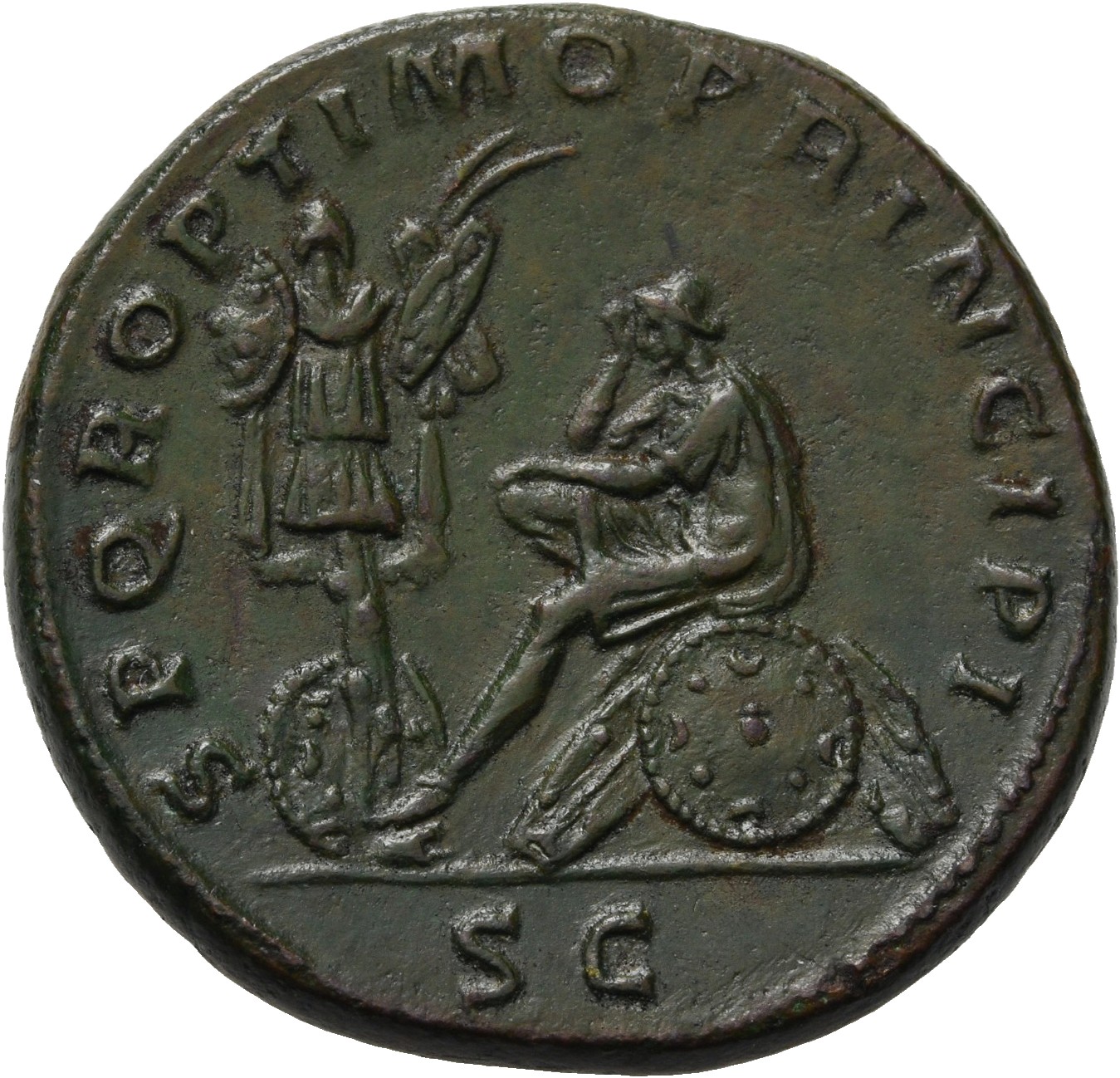 RIC II Trajan 563 Trajan reverse, Dacia, seated left, in attitude of mourning on shield and pile of arms; before her on le...