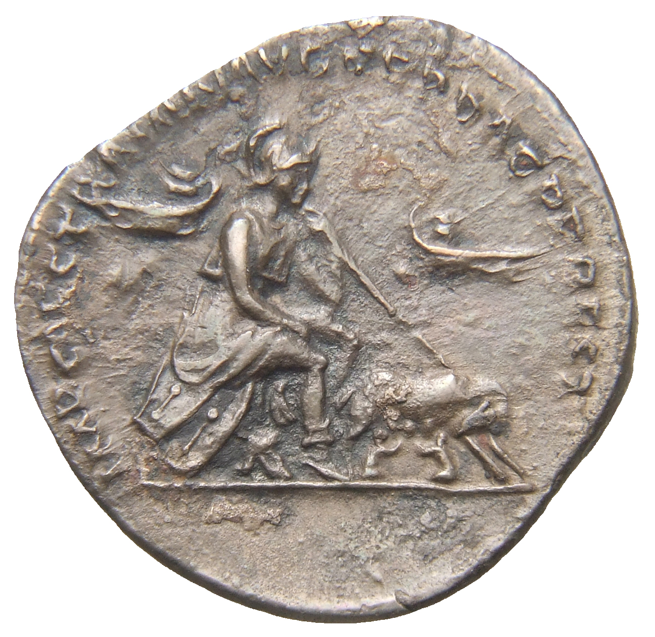 RIC II Trajan 771 Trajan reverse, Roma seated right; she-wolf and twins in front; prows in field