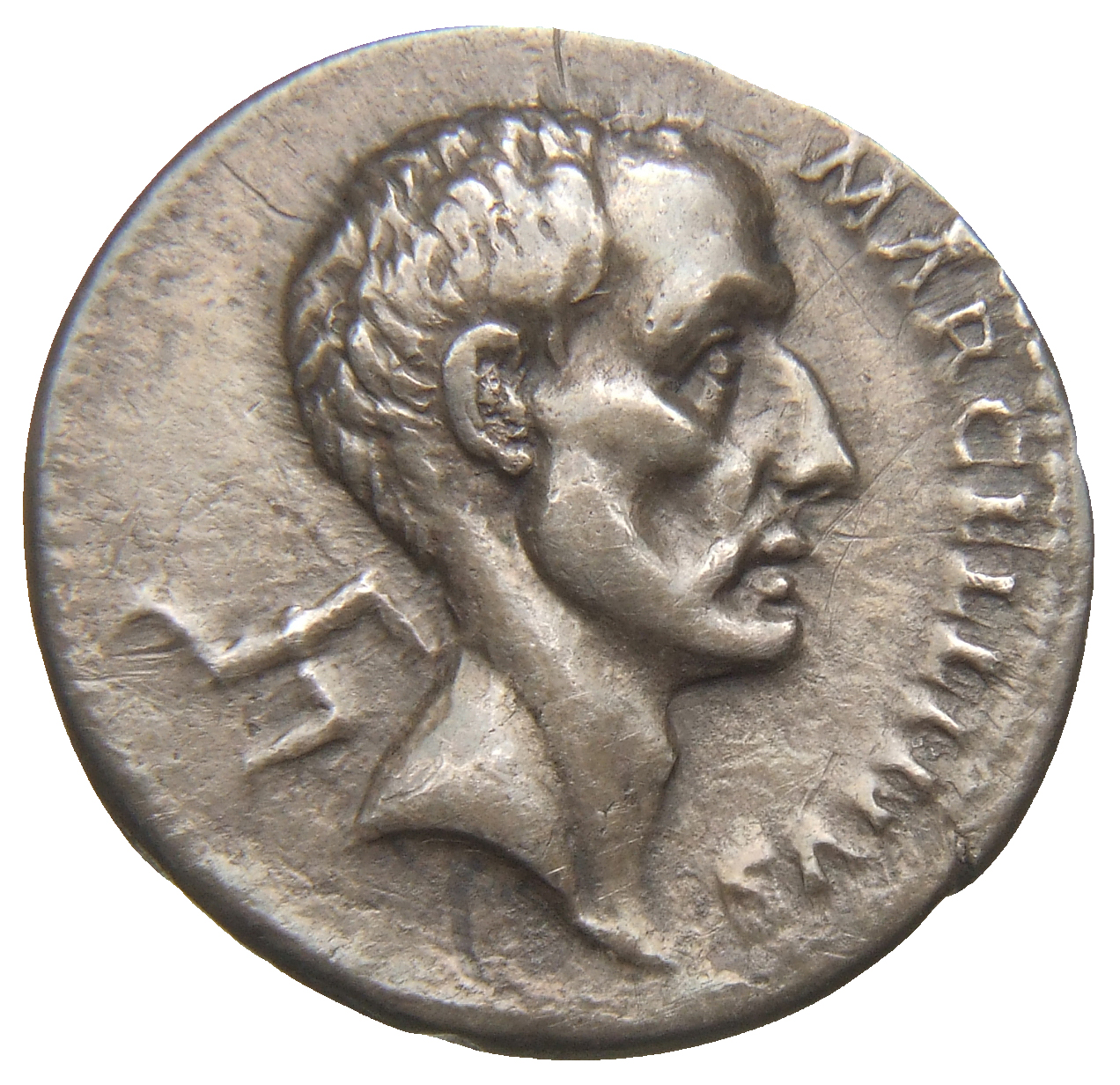 RIC II Trajan 809 Trajan obverse, Head of Marcus Claudius Marcellus, bare, right; triskelis behind