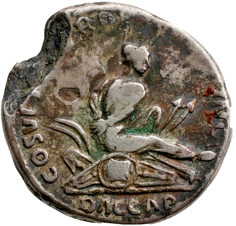 RIC II Trajan 96 Trajan reverse, Dacian, his hands bound behind him, seated right on a pile of shields and arms