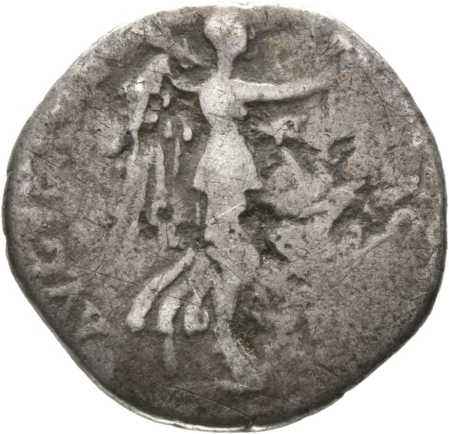 Vespasian reverse — Victory, draped, advancing right, holding wreath extended in right hand and palm over left shoulder in left