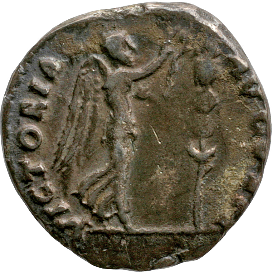 Vespasian reverse — Victory, draped, advancing right, holding palm over left shoulder in left hand and with right about to place wreath on a standard set on ground