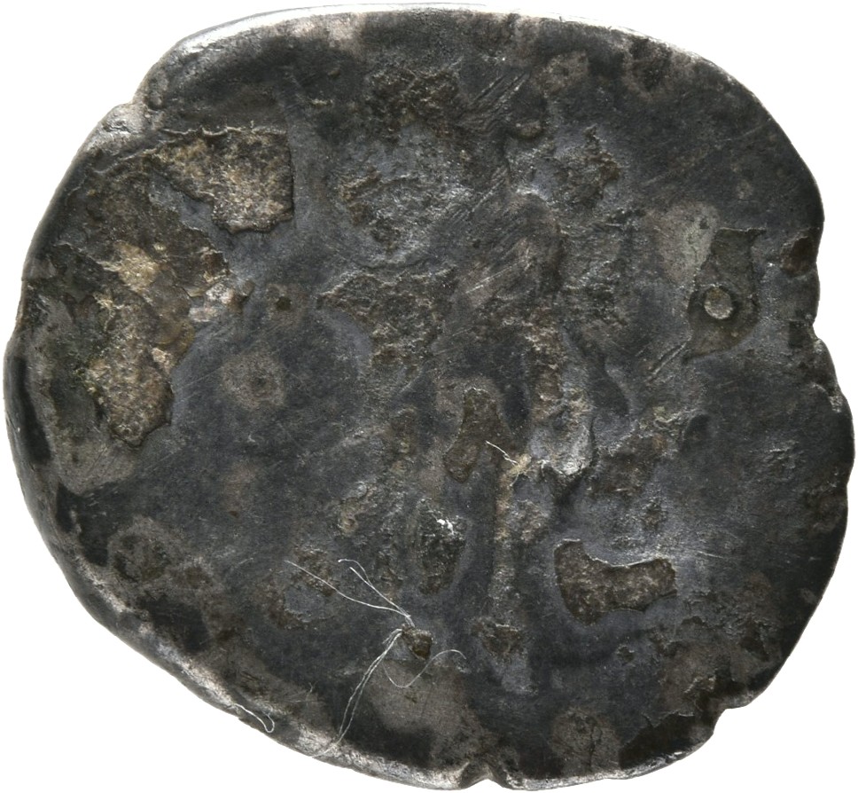 Antoninus Pius reverse — Annona, draped, standing left, holding two corn-ears downwards in right hand and resting left on modius set on prow. right