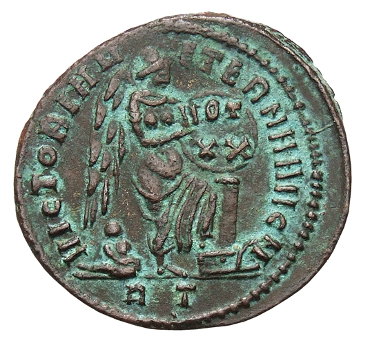 RIC VI Rome 235 Maxentius reverse, Victory, winged, draped, standing right, inscribing VOT/XX on shield supported by pilla...