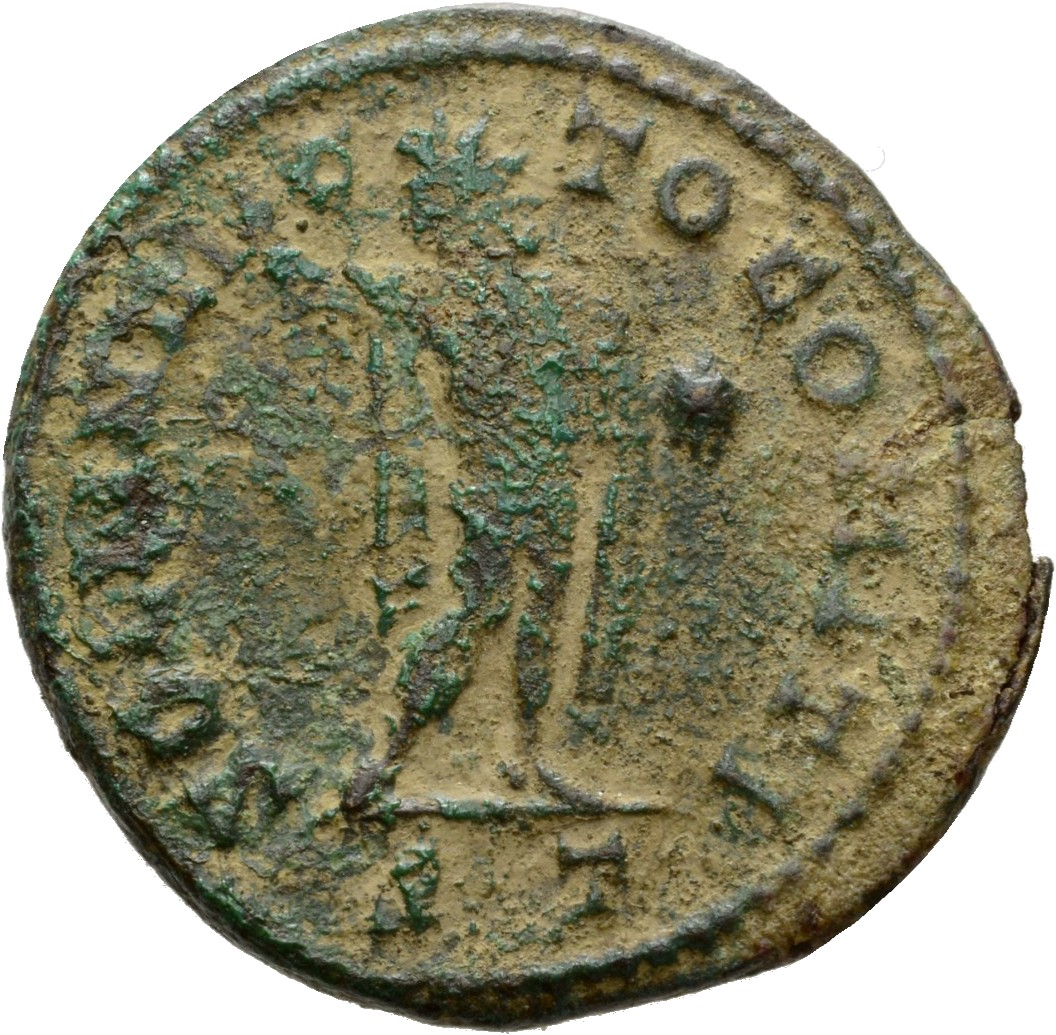 RIC VI Ticinum 130 Constantine I reverse, Sol, chlamys draped over left shoulder, standing right, head left, raising right...