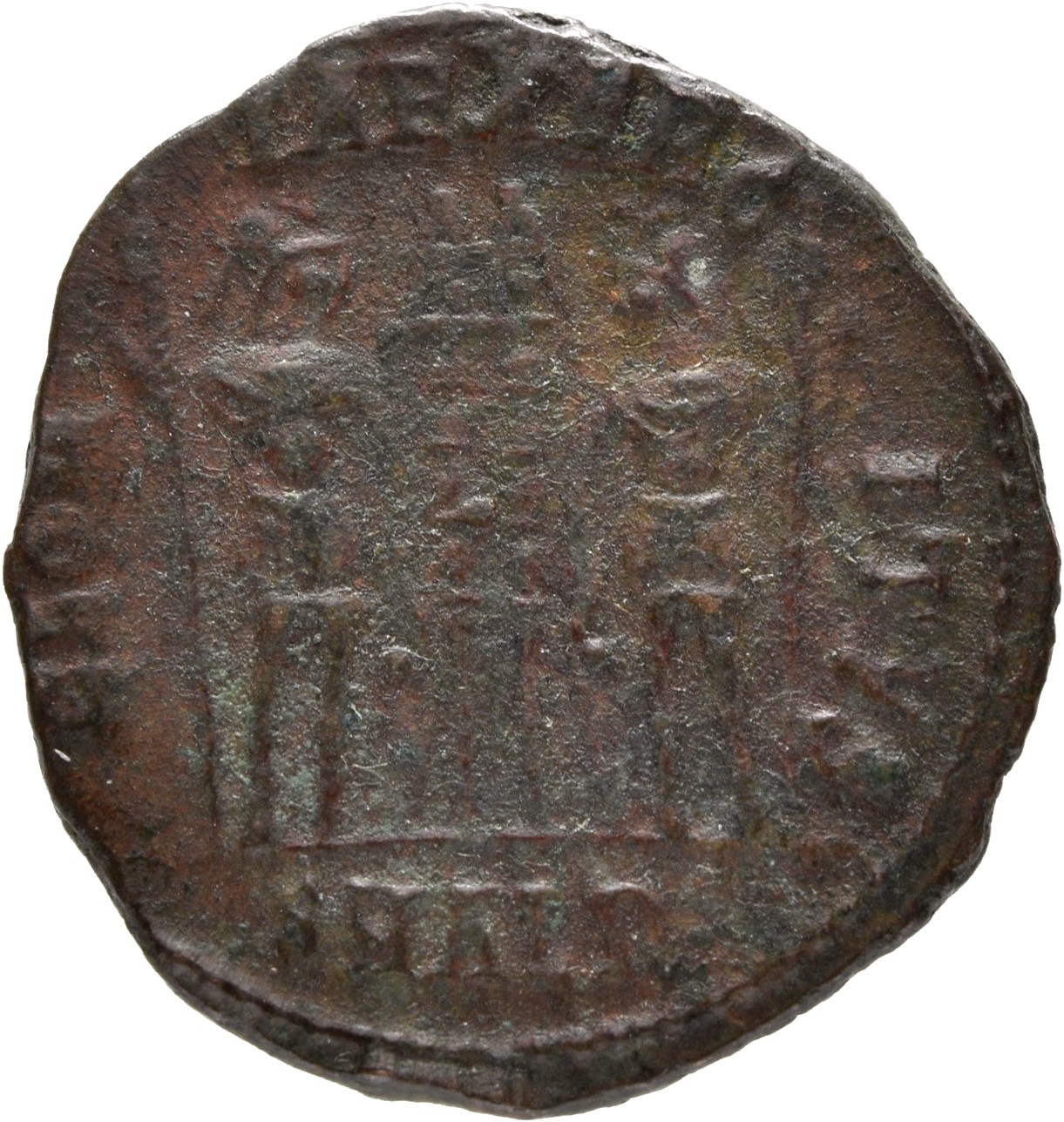 Constantine I reverse — Two soldiers, helmeted, draped, cuirassed, standing facing each other, each holding reversed spear in outer hand and resting inner hand on shield; between them, two standards