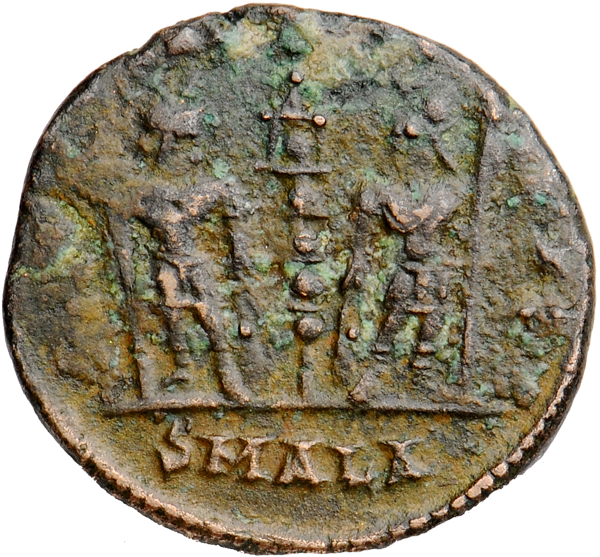 Constantine I reverse — Two soldiers, helmeted, draped, cuirassed, standing facing each other, each holding reversed spear in outer hand and resting inner hand on shield; between them, a standard