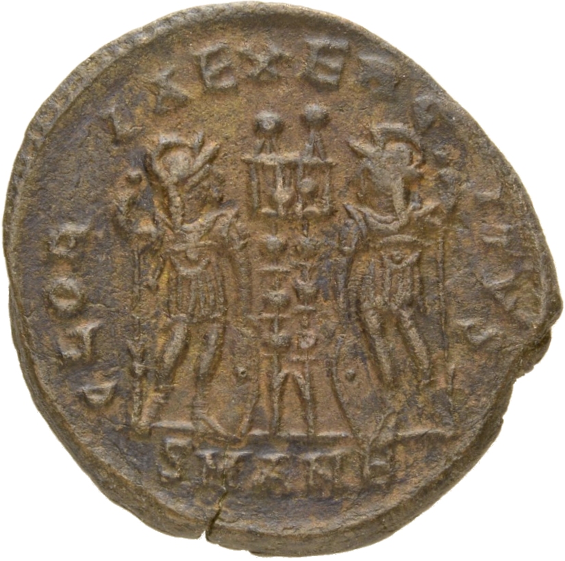 Constantine I reverse — Two soldiers, helmeted, draped, cuirassed, standing facing each other, each holding reversed spear in outer hand and resting inner hand on shield; between them, two standards