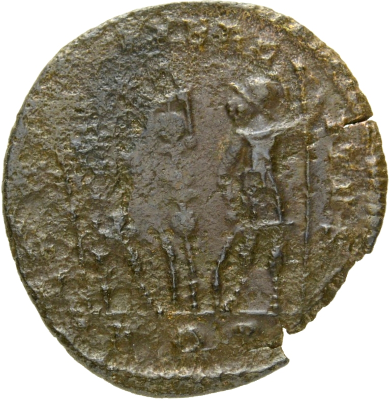 Constantine I reverse — Two soldiers, helmeted, draped, cuirassed, standing facing each other, each holding reversed spear in outer hand and resting inner hand on shield; between them, a standard