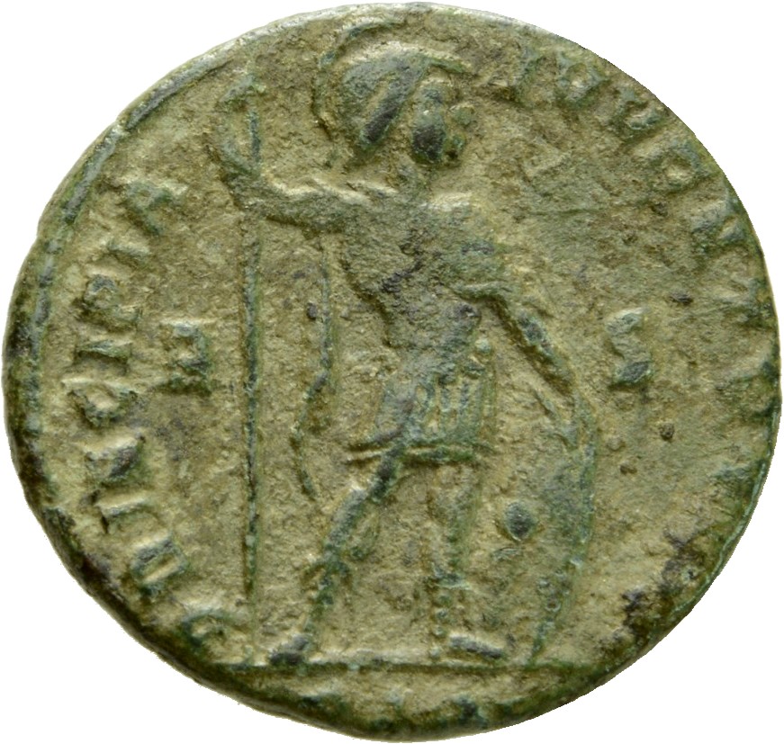 Constantine I reverse — Mars, helmeted, draped, cuirassed, chlamys draped across left shoulder, standing right, leaning on shield with right hand and holding reversed vertical spear with left hand