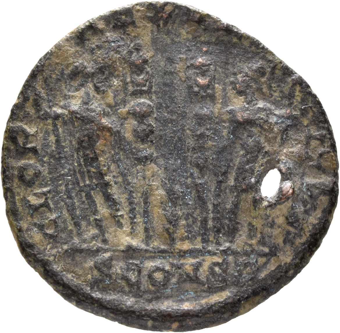 Constantine I reverse — Two soldiers, helmeted, draped, cuirassed, standing facing each other, each holding spear in outer hand and resting inner hand on shield; between them, two standards