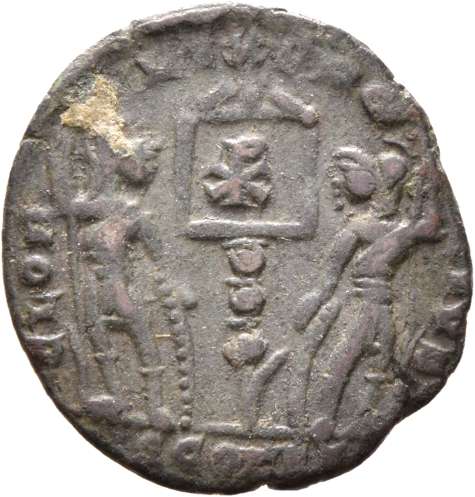Constantine I reverse — Two soldiers, helmeted, draped, cuirassed, standing facing each other, each holding spear in outer hand and resting inner hand on shield; between them, two standards