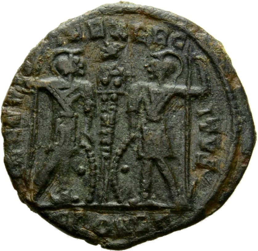 Constantine I reverse — Two soldiers, helmeted, draped, cuirassed, standing facing each other, each holding reversed spear in outer hand and resting inner hand on shield; between them, a standard