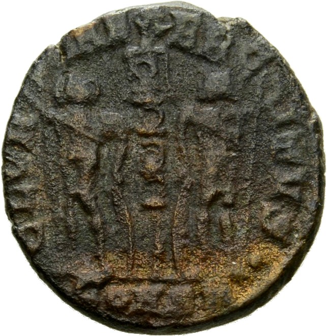 Constantine I reverse — Two soldiers, helmeted, draped, cuirassed, standing facing each other, each holding reversed spear in outer hand and resting inner hand on shield; between them, a standard