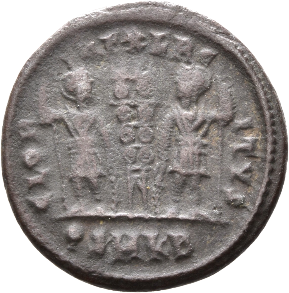 Constantine I reverse — Two soldiers, helmeted, draped, cuirassed, standing facing each other, each holding spear in outer hand and resting inner hand on shield; between them, two standards