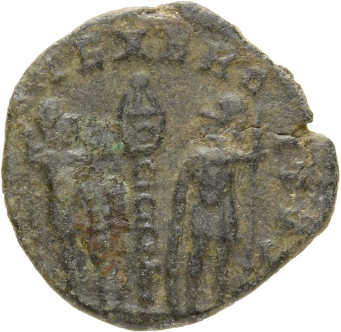 Constantine I reverse — Two soldiers, helmeted, draped, cuirassed, standing facing each other, each holding spear in outer hand and resting inner hand on shield; between them, a standard