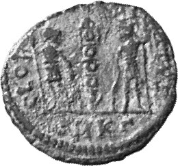 Constantine I reverse — Two soldiers, helmeted, draped, cuirassed, standing facing each other, each holding spear in outer hand and resting inner hand on shield; between them, a standard