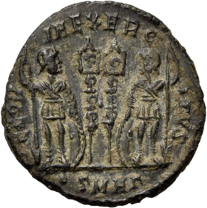 RIC VII Heraclea 117 Constantine I reverse, Two soldiers, helmeted, draped, cuirassed, standing facing each other, each ho...
