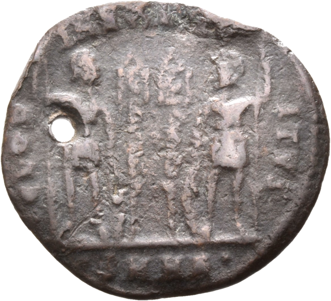 Constantine I reverse — Two soldiers, helmeted, draped, cuirassed, standing facing each other, each holding spear in outer hand and resting inner hand on shield; between them, two standards