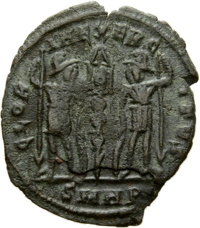 Constantine I reverse — Two soldiers, helmeted, draped, cuirassed, standing facing each other, each holding spear in outer hand and resting inner hand on shield; between them, a standard