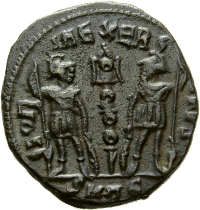Constantine I reverse — Two soldiers, helmeted, draped, cuirassed, standing facing each other, each holding spear in outer hand and resting inner hand on shield; between them, a standard