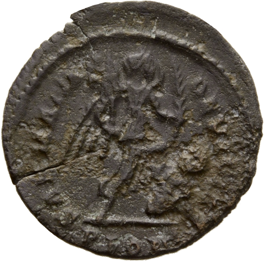 Constantine I reverse — Victory, winged, draped, advancing right, holding trophy on right arm and branch in left hand, trampling seated captive