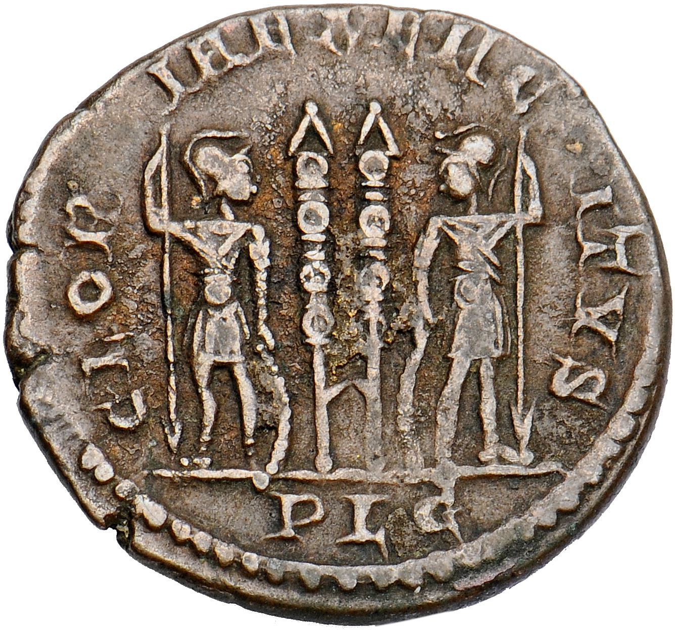Constantine I reverse — Two soldiers, helmeted, draped, cuirassed, standing facing each other, each holding reversed spear in outer hand and resting inner hand on shield; between them, two standards
