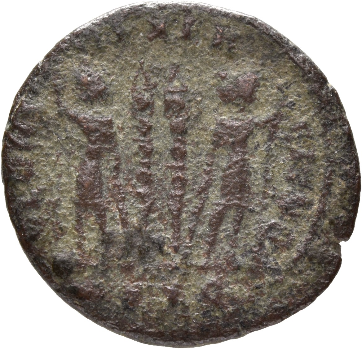 Constantine I reverse — Two soldiers, helmeted, draped, cuirassed, standing facing each other, each holding reversed spear in outer hand and resting inner hand on shield; between them, two standards