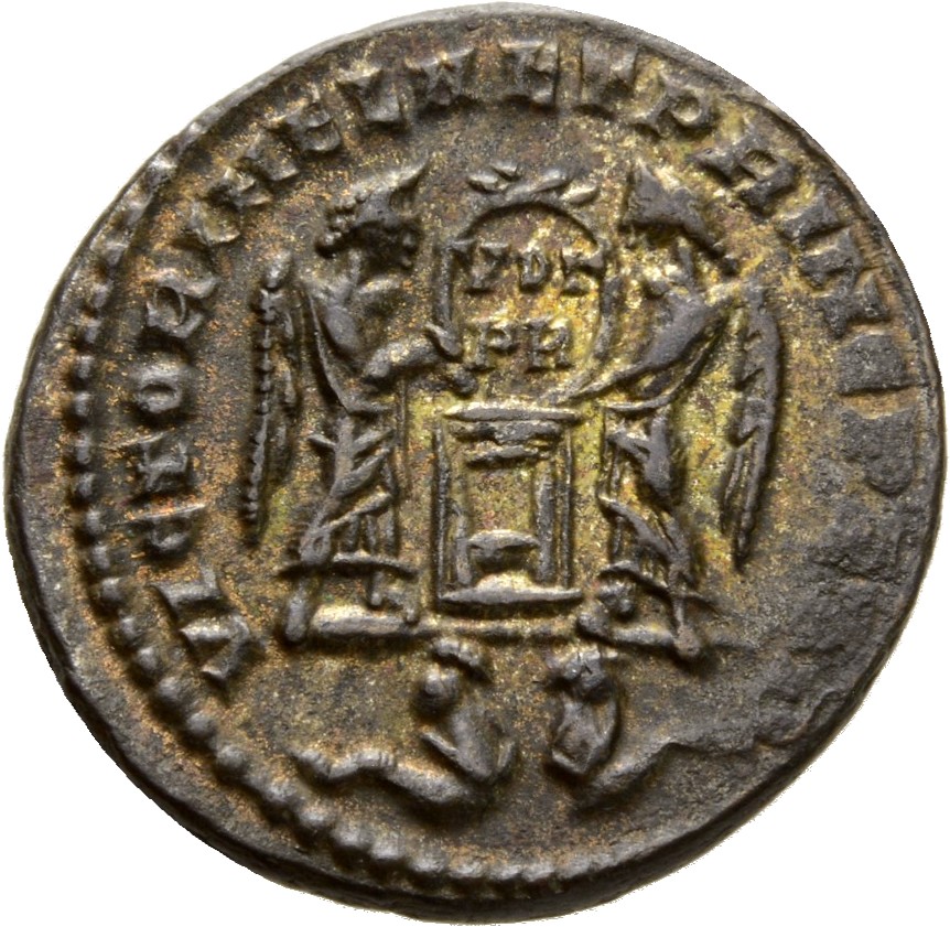 Constantine I reverse — Two Victories, winged, draped, facing each other, holding a shield inscribed VOT/PR supported by an altar