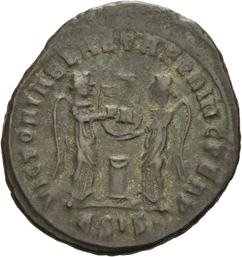 RIC VII Siscia 59 Constantine I reverse, Two Victories, winged, draped, facing each other, holding a shield inscribed VOT/...