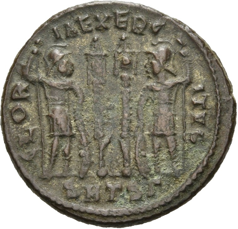 RIC VII Thessalonica 185 Constantine I reverse — Two soldiers, helmeted, draped, cuirassed, standing facing each other, ea...