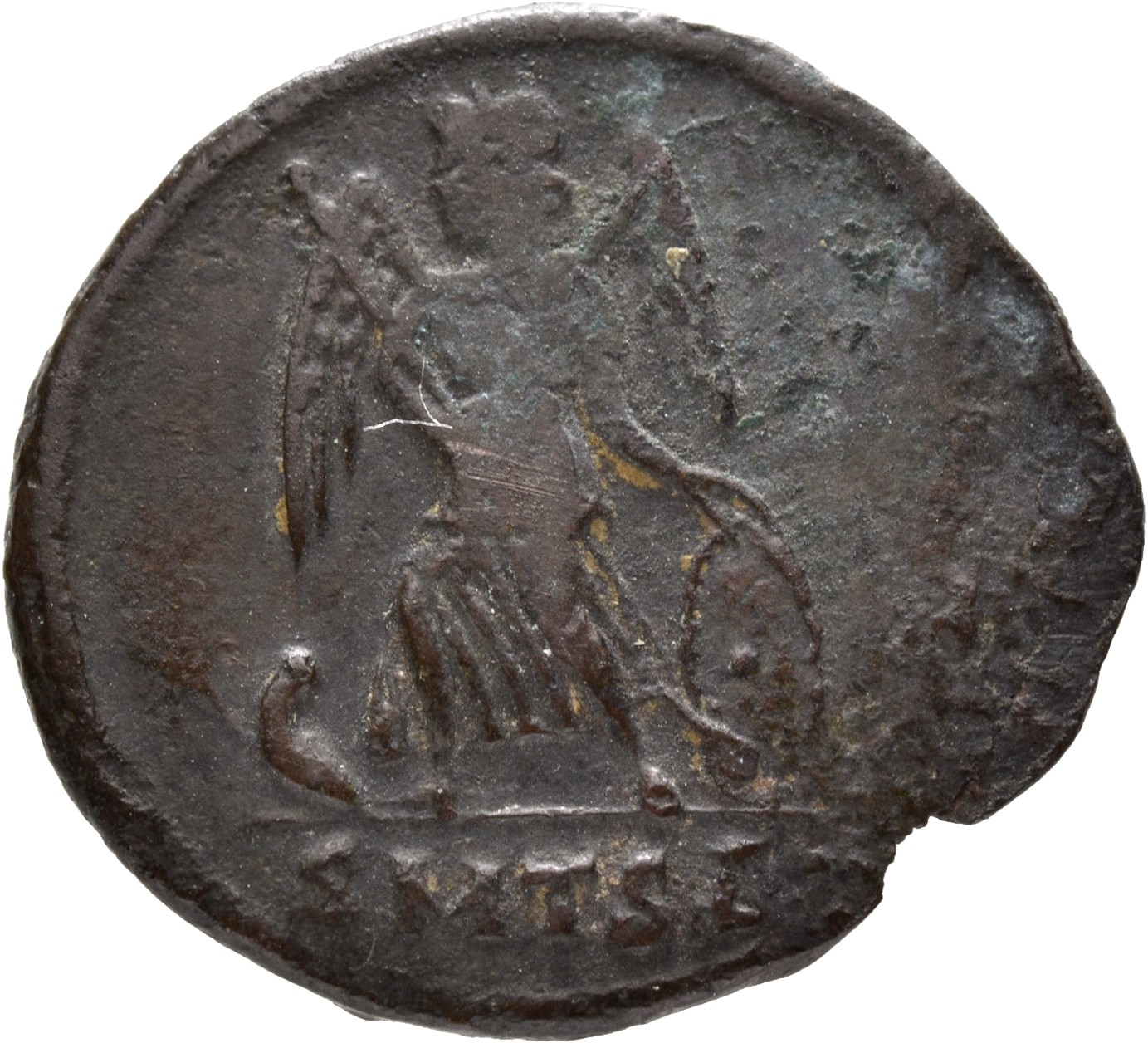 Constantine I reverse — Victory, winged, draped, standing left on prow, holding spear in right hand and shield in left hand