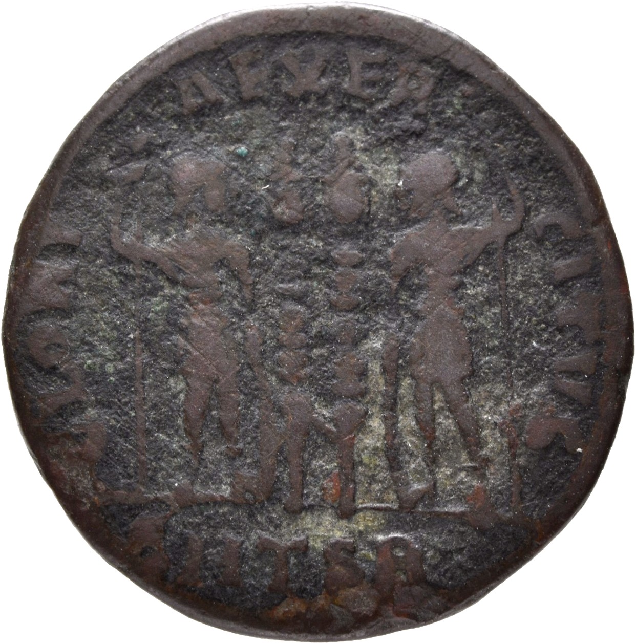Constantine I reverse — Two soldiers, helmeted, draped, cuirassed, standing facing each other, each holding reversed spear in outer hand and resting inner hand on shield; between them, two standards