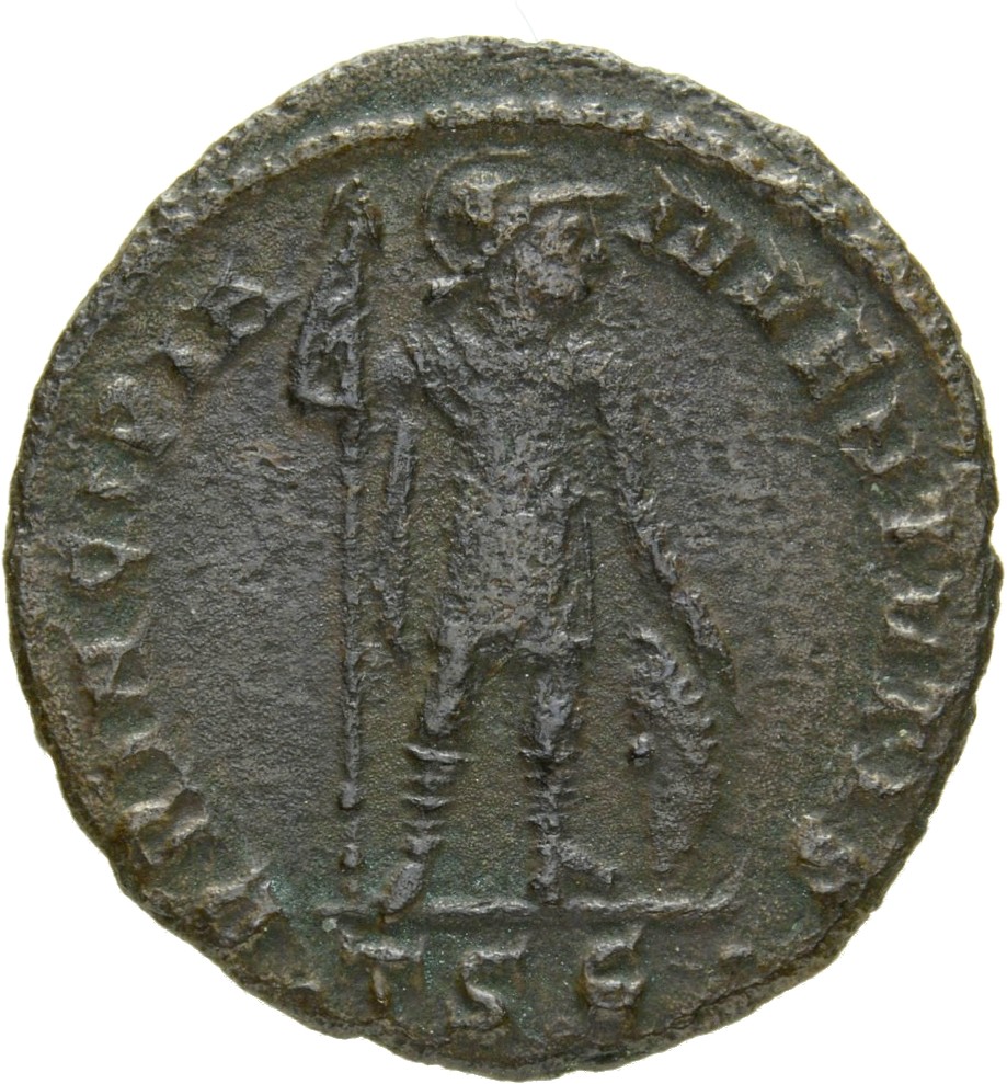 Constantine I reverse — Crispus, draped, cuirassed, cloak spread, standing right, placing right hand on shield and holding reversed spear in left hand