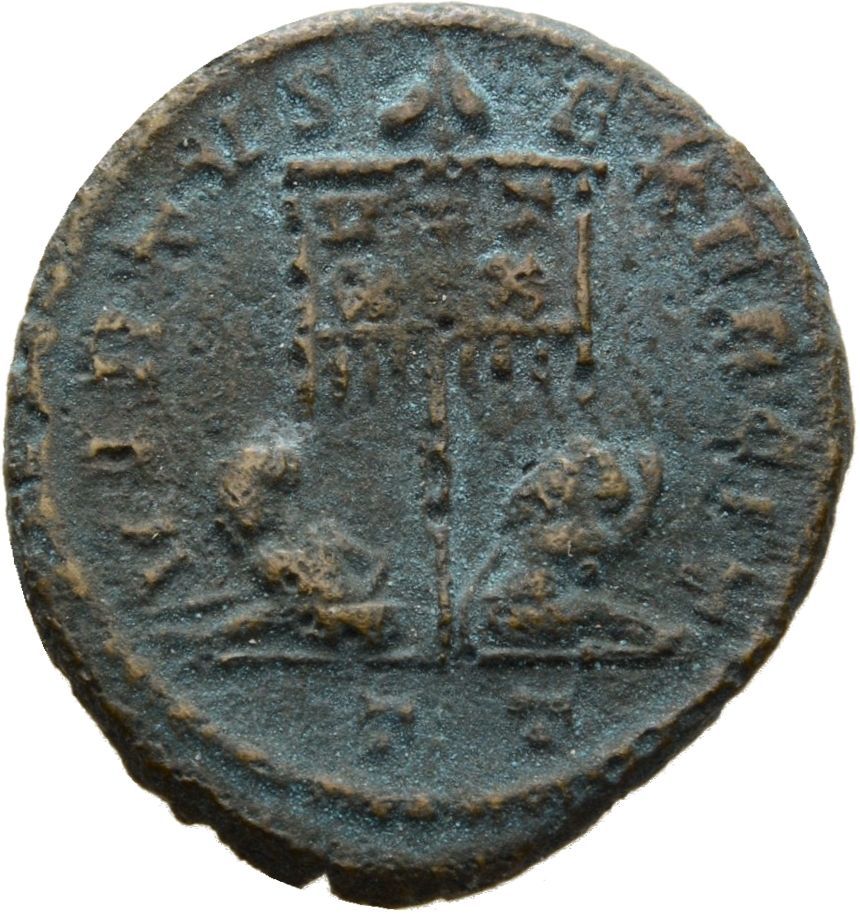 RIC VII Ticinum 117 Constantine I reverse, Standard with VOT/XX inscribed on drapery, flanked by two seated captives