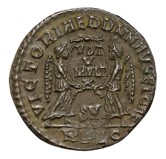 RIC VIII Lugdunum 126 Magnentius reverse, Two Victories, winged, draped, standing facing each other, holding between them ...