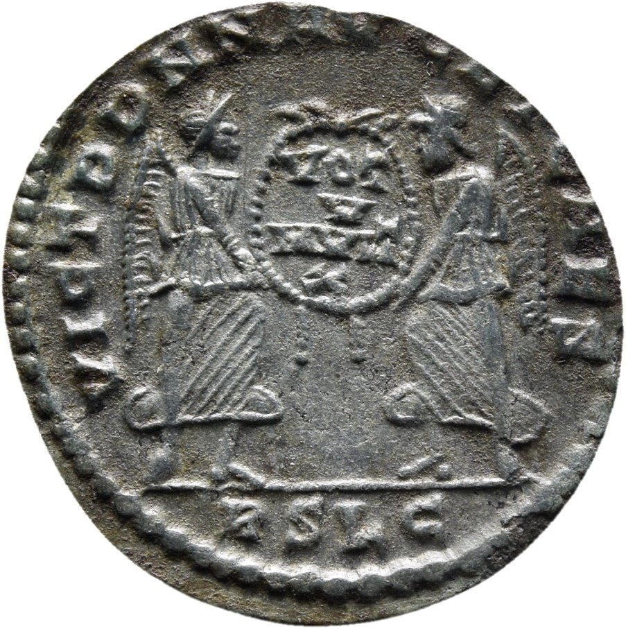 RIC VIII Lugdunum 151 Magnentius reverse, Two Victories, winged, draped, standing facing each other, holding between them ...