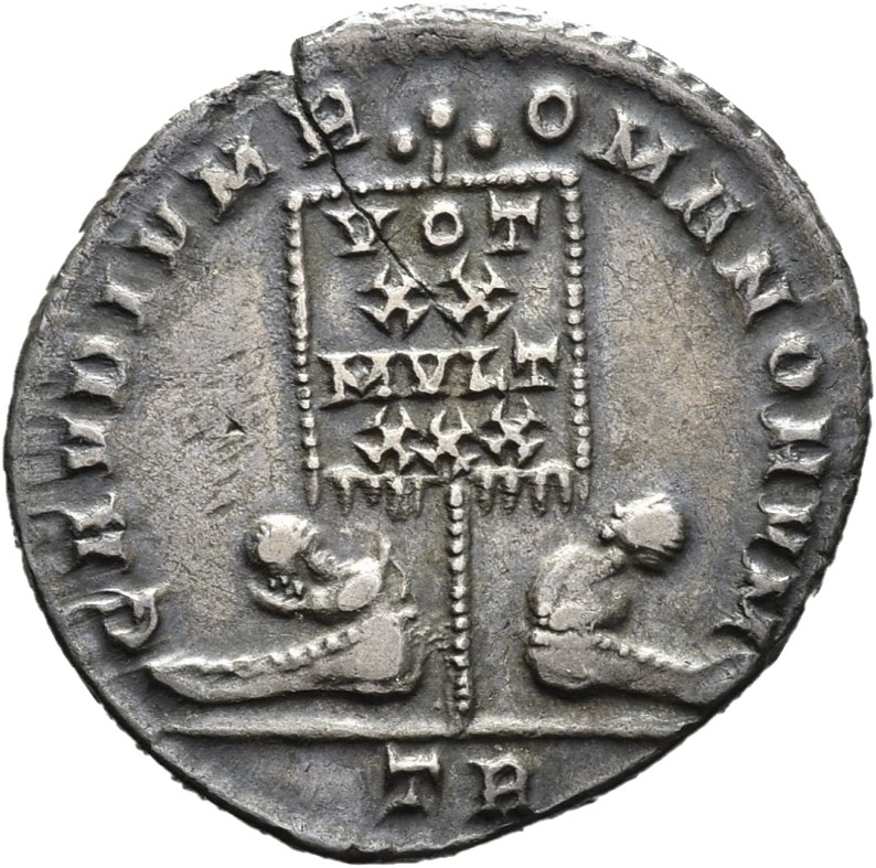 RIC VIII Treveri 153 Constans reverse, Standard, banner inscribed VOT/XX/MVLT/XXX, flanked by two bareheaded seated captives